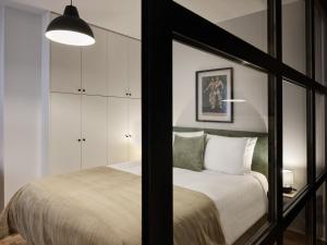 a bedroom with a large bed and a mirror at Sunny and Comfy 2bd Apt in Kolonaki in Athens