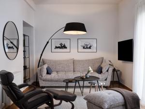 a living room with a couch and a table at Sunny and Comfy 2bd Apt in Kolonaki in Athens
