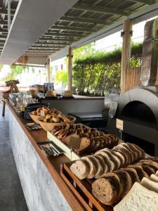 a buffet line with various types of bread on display at Mantra Samui Resort - Adults Only in Mae Nam