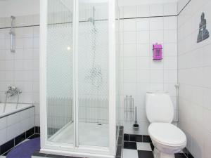 a white bathroom with a shower and a toilet at Holiday Home in Alkmaar by Canal in Alkmaar +33 photos