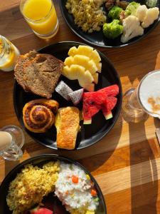 two plates of food on a wooden table at Mantra Samui Resort - Adults Only in Mae Nam