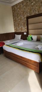 a large bed in a room with at Sky Pie hotel in Dharamshala