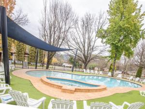 a swimming pool with chairs and a slide at NRMA Bright Holiday Park in Bright
