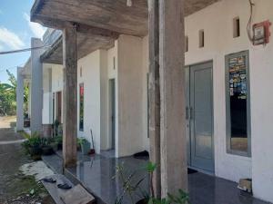 an outside view of a building with a porch at SPOT ON 93786 Kost Alamku Syariah 