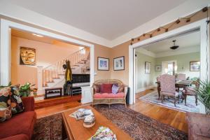 a living room with a couch and a table at Big beautiful house off Alberta—2 bdms sunny patio in Portland