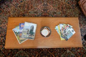 a wooden table with magazines and a clock on it at Big beautiful house off Alberta—2 bdms sunny patio in Portland