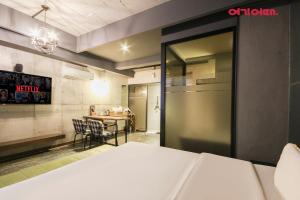 a room with a kitchen and a table with chairs at Hotel 109 in Busan