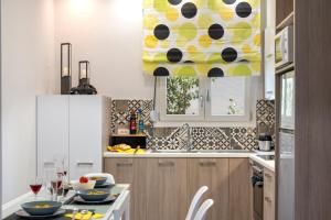 a kitchen with a table and a yellow and white at Chania Design Suites in Chania Town