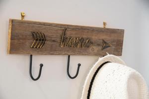 a wooden sign that reads home with an arrow and a towel at Chania Design Suites in Chania Town