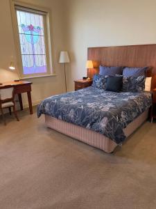 a bedroom with a bed and a stained glass window at The Astra Broken Hill in Broken Hill