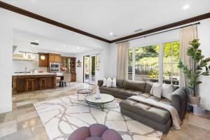 a living room with a couch and a table at @ Marbella Lane - 4BR Mediterranean-style Home in Newport Beach