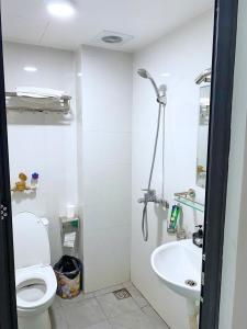 a bathroom with a toilet and a sink at GRAD Minh Trang Motel in Hanoi