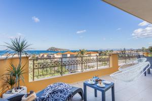 a balcony with a view of the ocean at kallia's lux apt with sea view & cool jacuzzi in Plataniás