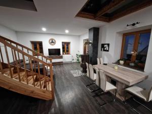 a living room with a wooden table and chairs at Paradise Oasis holiday house in Gornji Grad