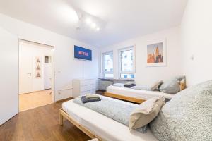 a bedroom with two beds and a window at NEW Luxury Apartment in Heilbronn, Ludwigsburg, Backnang, Stuttgart in Beilstein