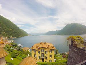 a large yellow building next to a large body of water at Studio Apartment Open Space with Terrace in Argegno