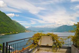 a view of a body of water with mountains at Studio Apartment Open Space with Terrace in Argegno