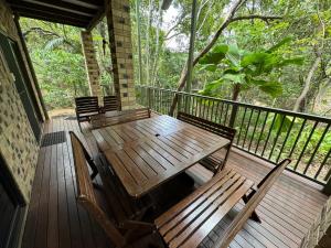 a porch with a wooden table and chairs on it at Avalon in Arcadia