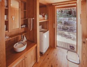 a bathroom with a sink and a toilet in a house at かたあきの里 in Miyako Island