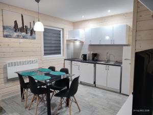 a kitchen with a table and chairs in a room at New holiday homes with a swimming pool, Rewal in Rewal