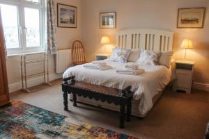 a bedroom with a bed with two towels on it at Waders in Salcombe