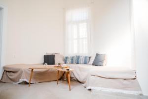 a living room with a couch and a table at Alcestis City Apartment in Rhodes Town