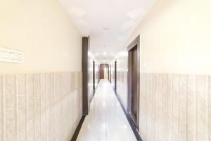 a corridor of an office building with white walls at FabHotel Shirdi Park Inn in Shirdi