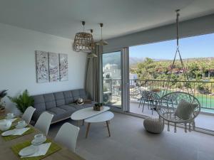 a living room with a couch and a table at Harbour lights by Smaris Collection in Sisi