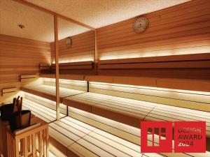 an empty sauna with a clock on the wall at Hiranoya in Gamagori