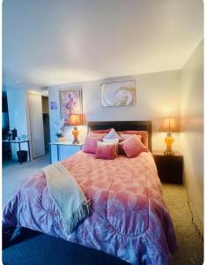 a bedroom with a large bed with pink pillows at Private Master Bedroom in Santa Clara
