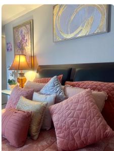 a bedroom with two beds with pillows and a lamp at Private Master Bedroom in Santa Clara