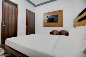 Postel nebo postele na pokoji v ubytování OYO Kohinoor Guest House