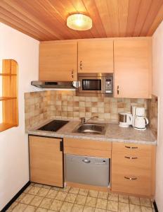 a kitchen with a sink and a microwave at Ferienwohnung Bergkristall in Krün