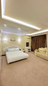 a large bedroom with two beds in a room at Hayot Hotel in Tashkent