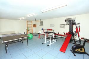 a room with a gym with a ping pong table at Gästehaus Christophorus - Edelweiß in Krün