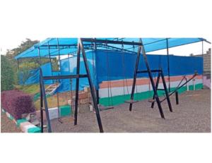 an empty swing set in a playground at Madhuvan Homestay, Junagarh in Sasan Gir