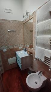 a bathroom with a sink and a mirror at Alta Quota Central on the Sea in Salerno