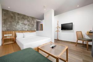 a hotel room with a bed and a tv at The Bayou Hotel Langkawi in Pantai Cenang