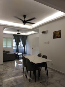 a living room with a table and a ceiling fan at 3 Bedrooms 2 Bathrooms Seruni Apartment, Serendah Gold Resort, Persiaran Meranti Selatan, Ulu Selangor, 48200 in Serendah