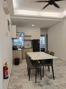 a kitchen and dining room with a table and chairs at 3 Bedrooms 2 Bathrooms Seruni Apartment, Serendah Gold Resort, Persiaran Meranti Selatan, Ulu Selangor, 48200 in Serendah