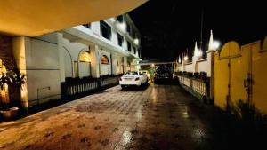 een witte auto geparkeerd op een straat 's nachts bij Hotel International Srinagar in Srinagar