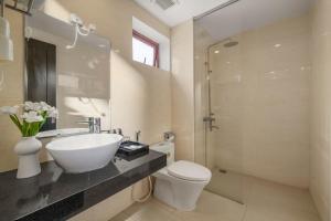 a bathroom with a sink and a toilet and a shower at Bantique Hotel in Da Nang