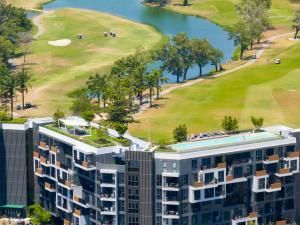 an aerial view of a building and a golf course at Апартаменты в Laguna Skypark с террасой in Bang Tao Beach