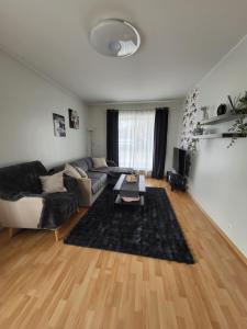 a living room with a couch and a table at Long Holiday Apartment in Kuressaare