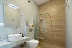 a bathroom with a shower and a toilet and a sink at Horizon Studios - Apartments in Rodakino +92 photos
