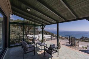 a patio with a view of the ocean at Horizon Studios - Apartments in Rodakino