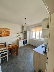 a kitchen with a table and a dining room at City Retreat in Eisenstadt Zentrum in Eisenstadt