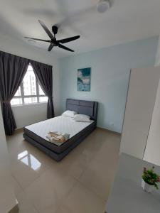 a bedroom with a bed with a ceiling fan at Bayu Temiang- Your Urban Retreat in Seremban