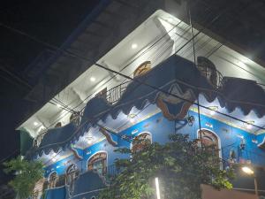 a blue building with balconies on the side of it at TRINCO VISTARA GUEST House in Trincomalee