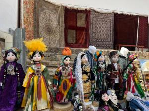 a group of figurines of people dressed in costumes at Ikat Terrace in Bukhara
